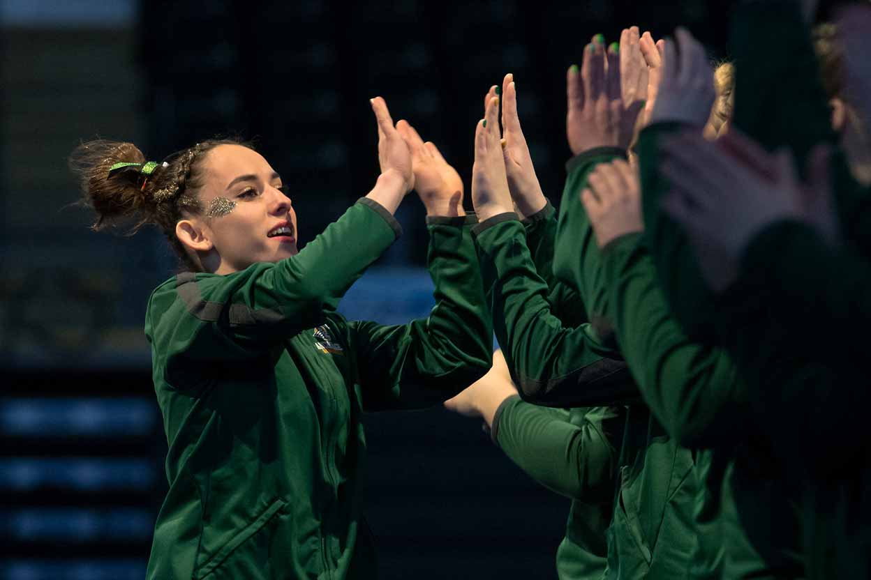 UAA gymnast Tere Alonso high-fives her teammates