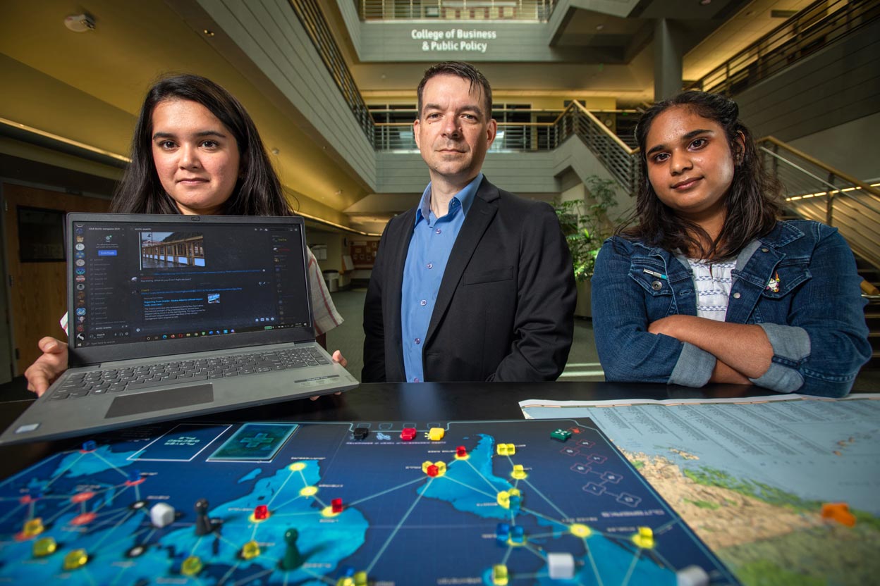 UAA Professor Chad Briggs and MPA graduate students Maya Narang and Cuckoo Gupta  demonstrate how their class uses Discord servers and board games to plan and run Arctic Strategy disaster scenarios.