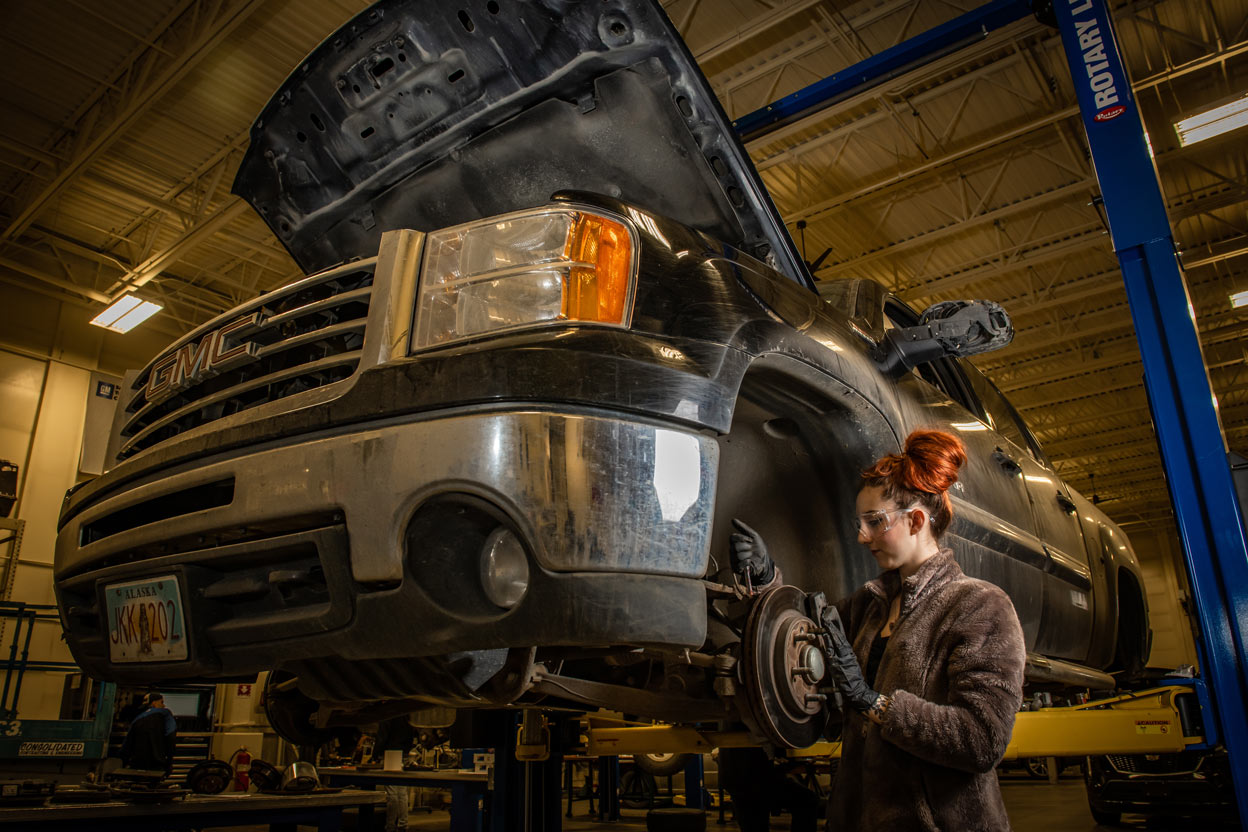 Automotive Technology student Mallory Hanna works on a brake assembly during instructor Randal Smith's brake systems (ADT A150) course in UAA's Automotive and Diesel Technology Building. (Photo by James Evans / UAA)