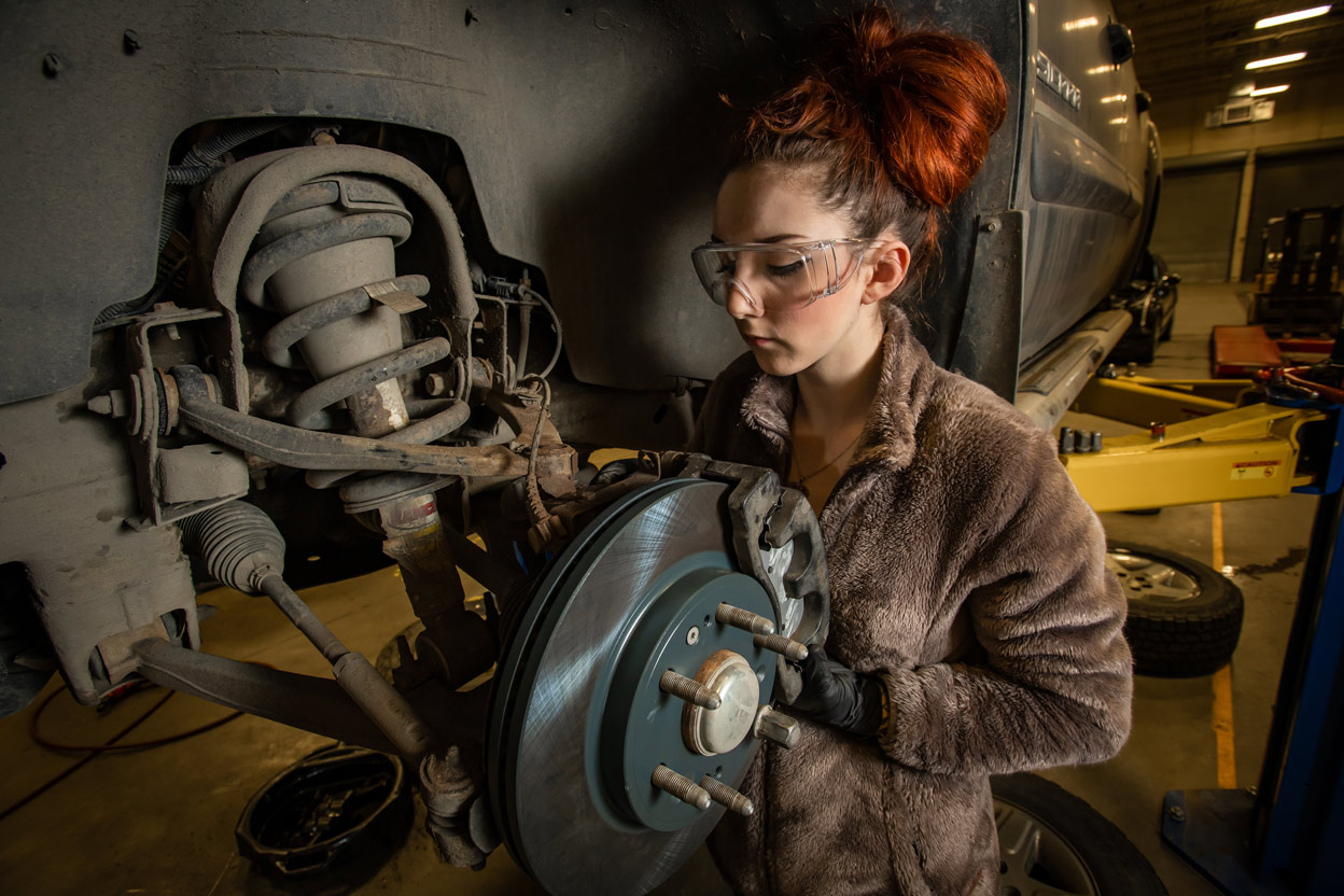 Automotive Technology student Mallory Hanna works on a brake assembly during instructor Randal Smith's brake systems (ADT A150) course in UAA's Automotive and Diesel Technology Building. (Photo by James Evans / UAA)