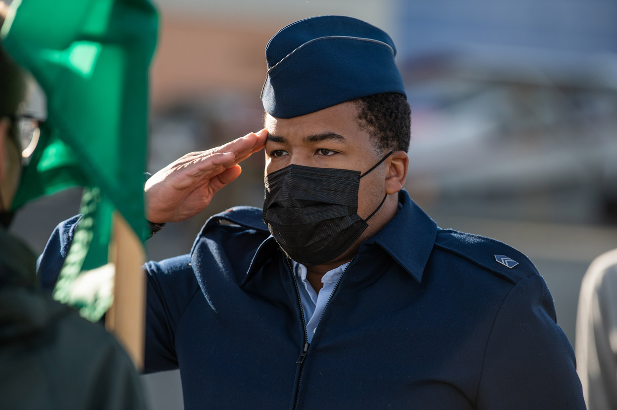 Cadet Nicholas Jenkins salutes as he and other members of UAA's Air Force Reserve Officer Training Corps (AFROTC) Detachment 001 practice drill outside UAA's Aviation Technology Center on Merrill Field. (Photo by James Evans / UAA)