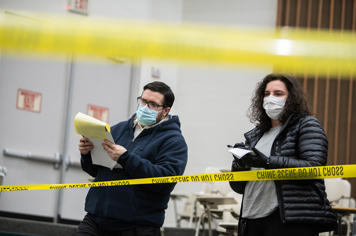 UAA Justice students John Whitlock and Fluturie Alimi collect and analyze evidence at a mock crime scene set up in a lecture hall in the Professional Studies Building for their practicum in Glen Klinkhart's criminal investigation course (JUST A255).