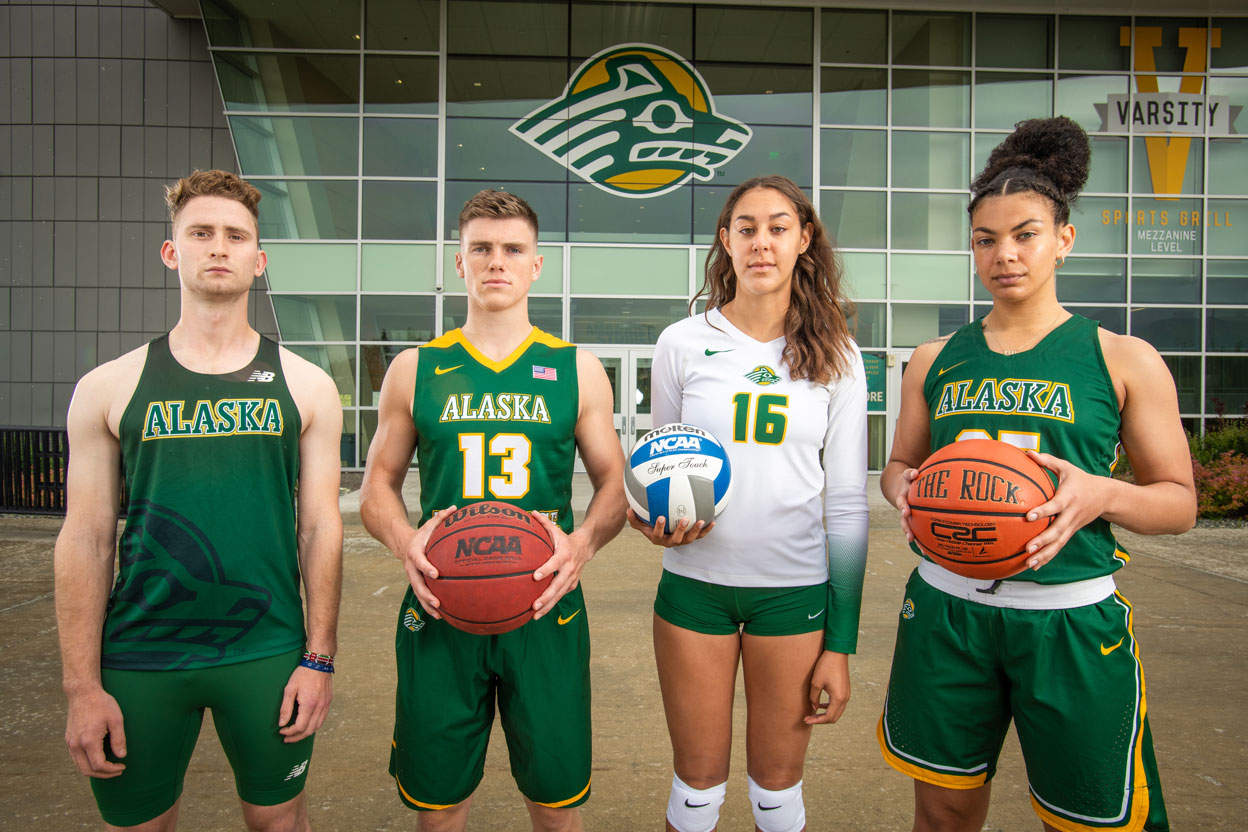 Alaska Airlines student-athletes Daryl Bushnell, B.S. ’22; Tobin Karlberg, B.A. ’22; Eve Stephens, B.B.A. ’22; and Tennae Voliva, B.S. ’21 in front of the Alaska Airlines Center. (Photo by James Evans / University of Alaska Anchorage)