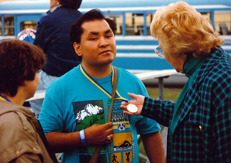 Arliss Sturgulewski congratulates an athlete in the Special Olympics Alaska, 1990