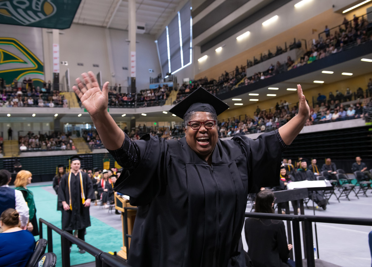 Cheryl Williams, B.A. Psychology, walks to receive her degree at UAA's Spring 2022 Commencement at the Alaska Airlines Center. (Photo by James Evans / University of Alaska Anchorage)