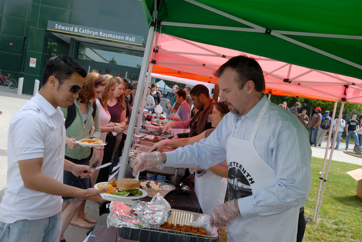 Bruce Schultz serves food during UAA's 2015 Juneteenth celebration.