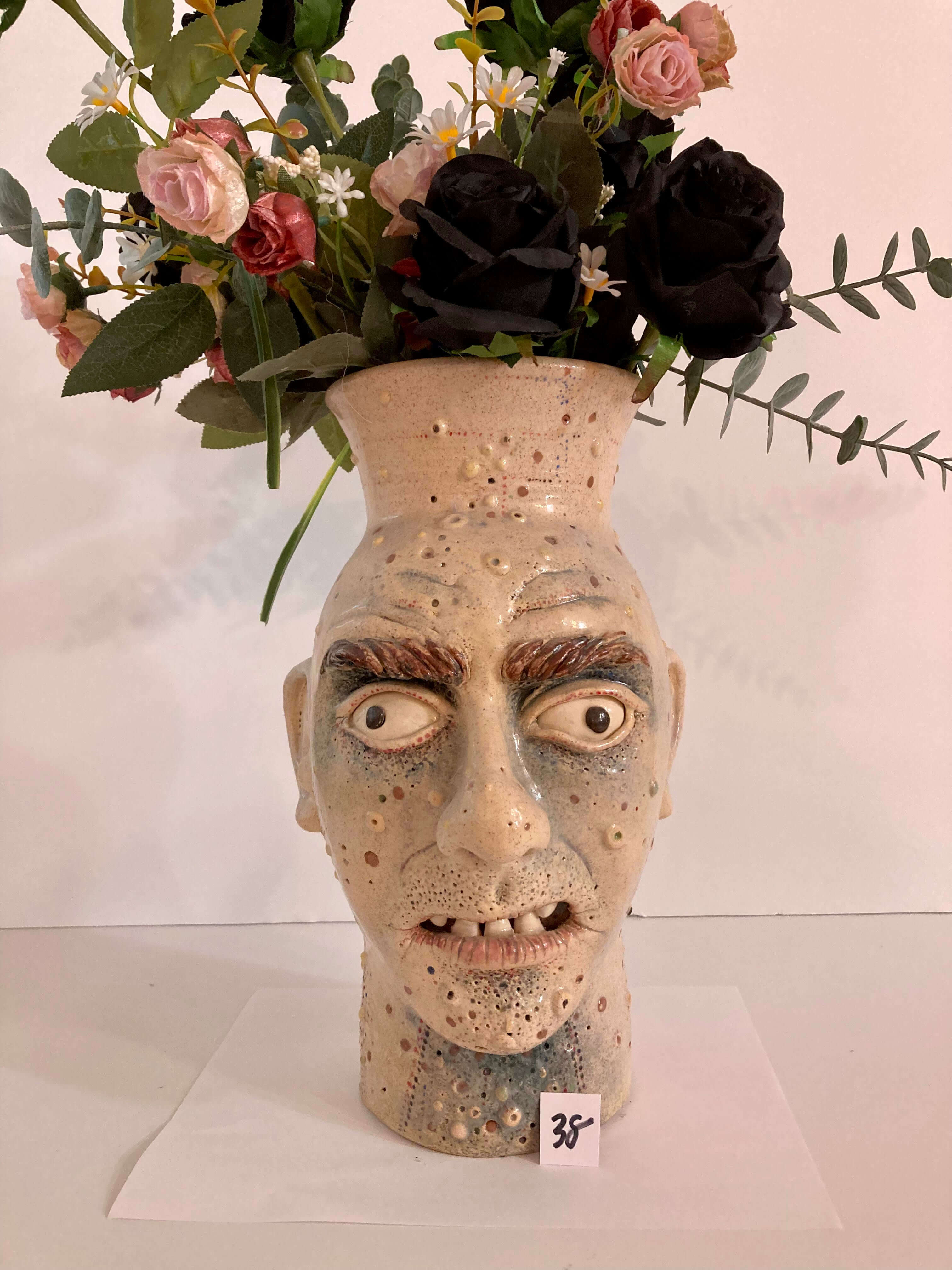 image of glazed stoneware vase titled scowling man by ronald viol