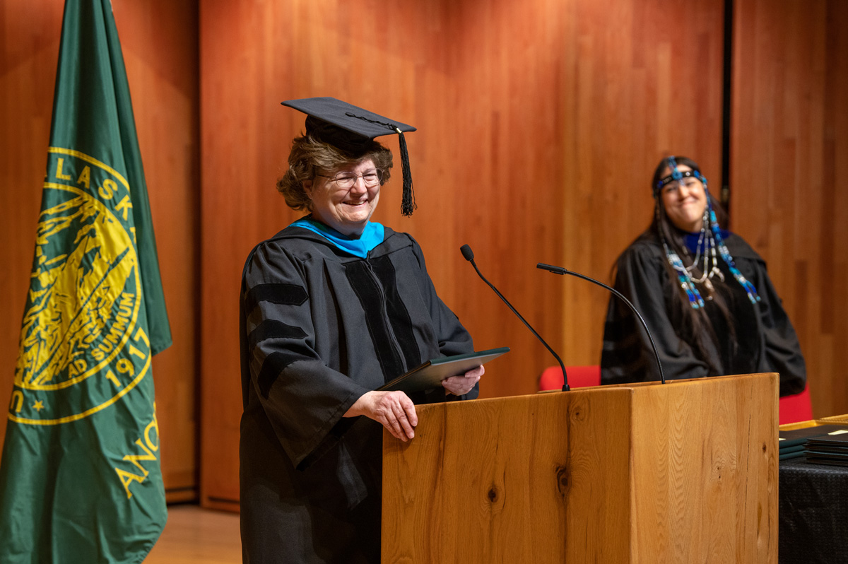 Janet Burton is honored with a staff emeritus award from Alaska Native Education & Outreach Michele Yatchmeneff.