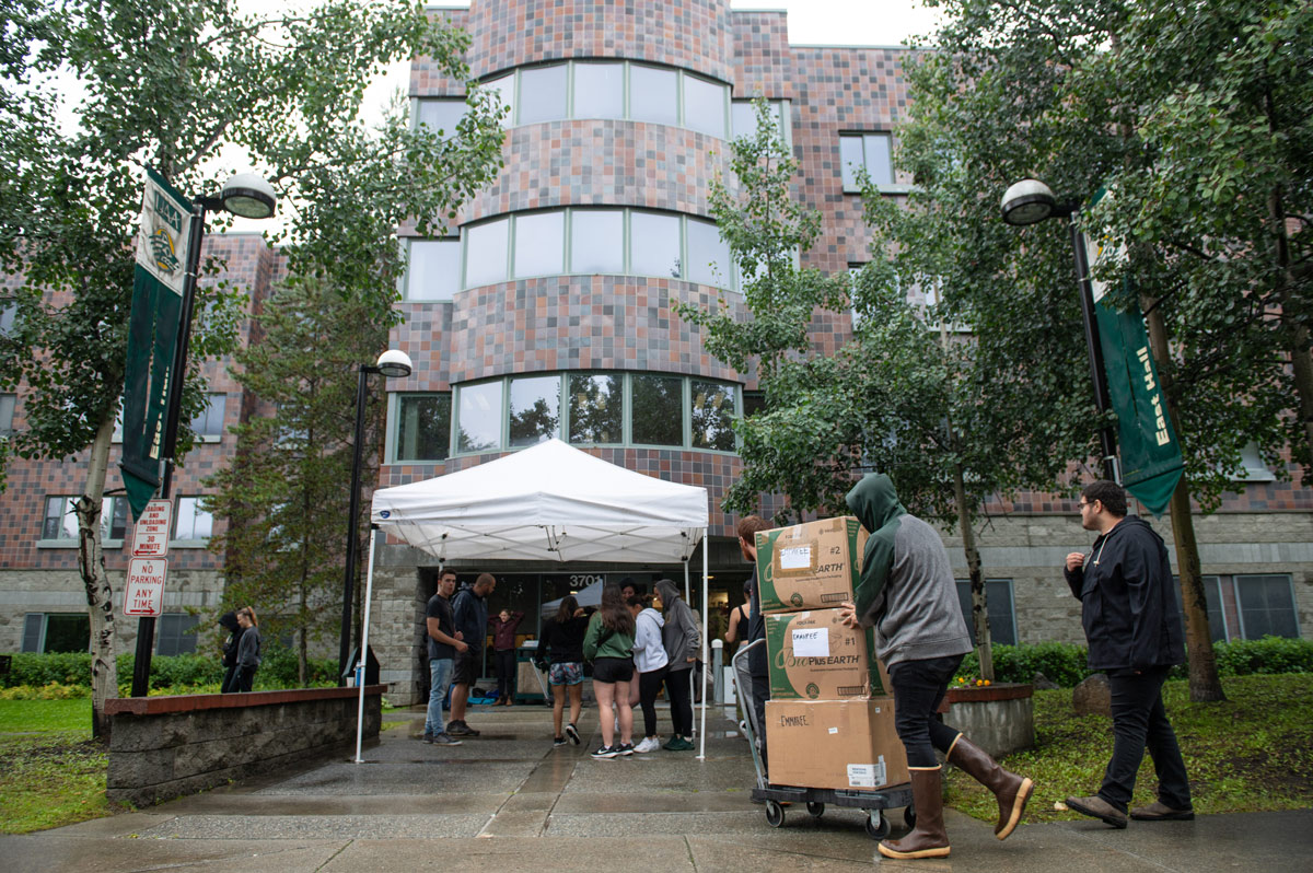 Students move into the residence halls during a very rainy Student Housing Check-in Day on Aug. 24, 2023.