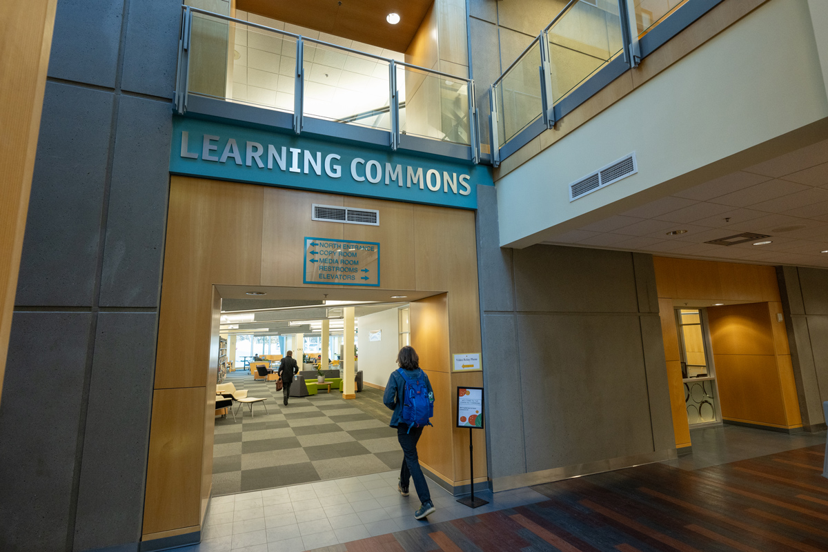 A student enters the Learning Commons' new location in the Consortium Library. (Photo by James Evans / UAA)
