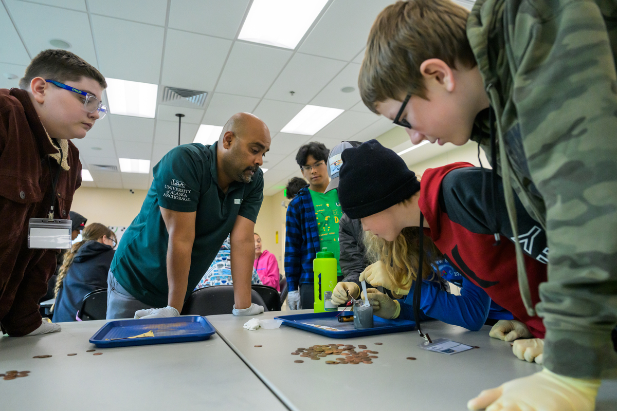 Middle school students learn to separate hydrogen from water using electrolysis as UAA mechanical engineering professor Raghu Srinivasan teaches a UAA Summer Engineering Academy focusing on corrosion chemistry in UAA's Engineering and Computation Building.