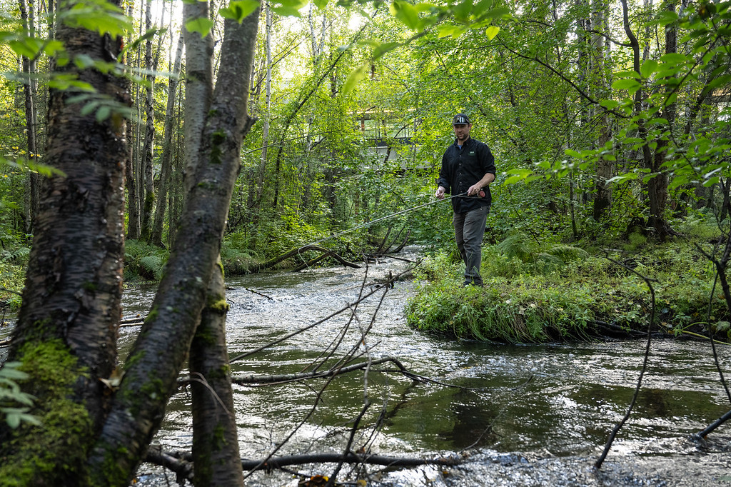Chair of Auto/Diesel programs Darrin Marshall and Diesel Power Technology professor Nate Berry fly fish for rainbow trout on Chester Creek where it flows under the UAA Spine.
