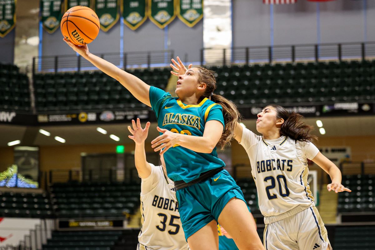 Mack playing basketball against the Bobcats