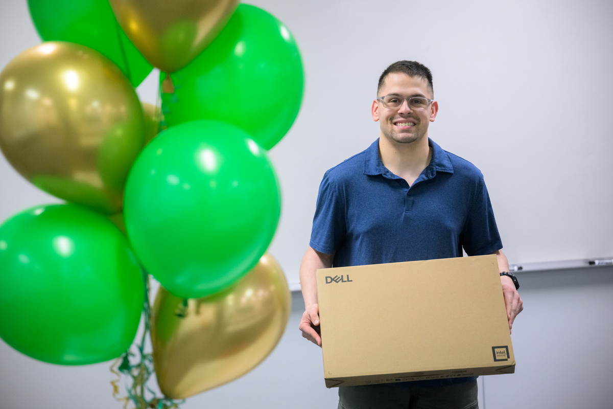 Student David Murray is surprised with a new Dell laptop after class.