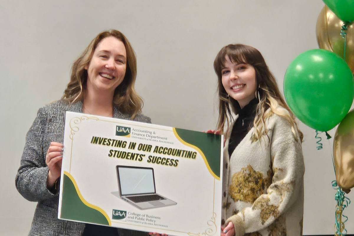 Professor of Accounting Stasia Straley surprises student Alli Lightle with a new Dell laptop after class.
