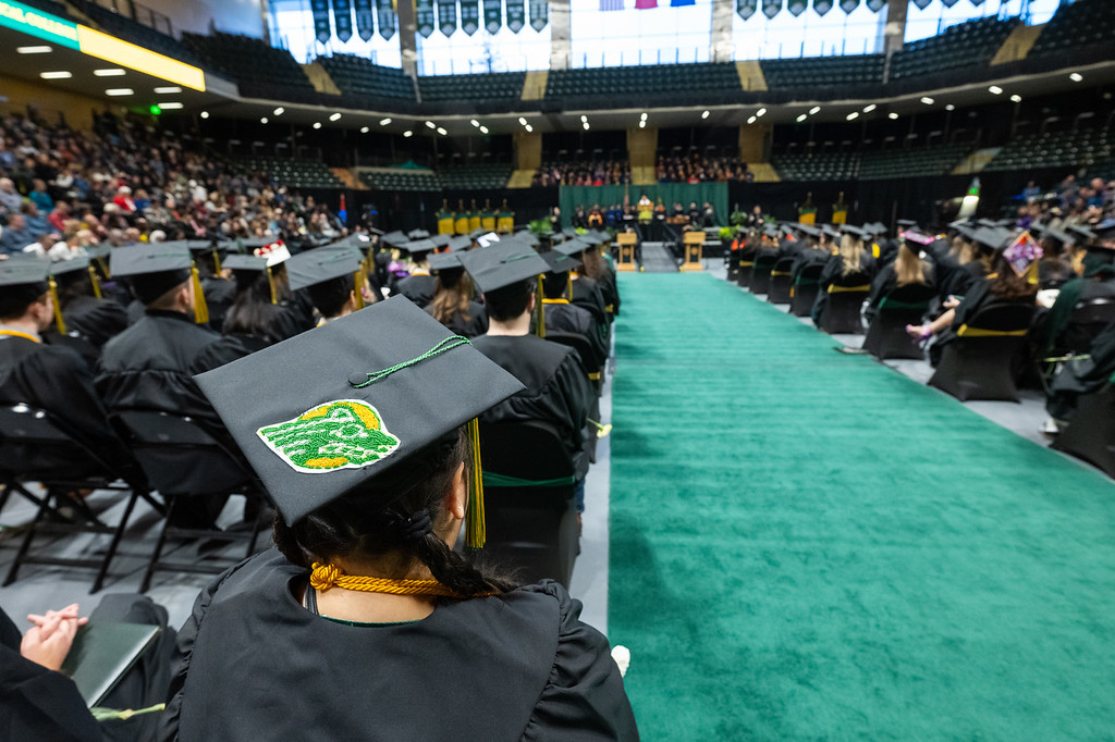Analouise Hoseth wears a beaded Seawolf on her cap at UAA's 2023 Fall Commencement in the Alaska Airlines Center.