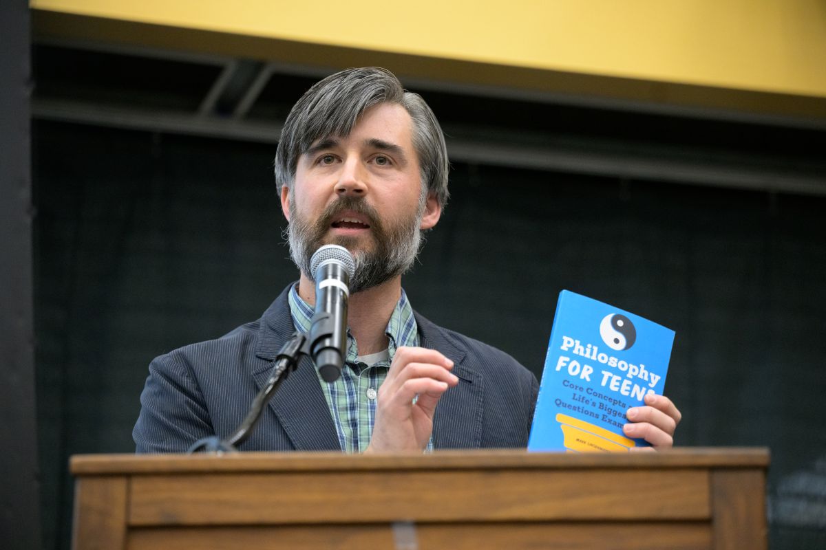 Joel Potter holding the book 'Philosophy for Teens'