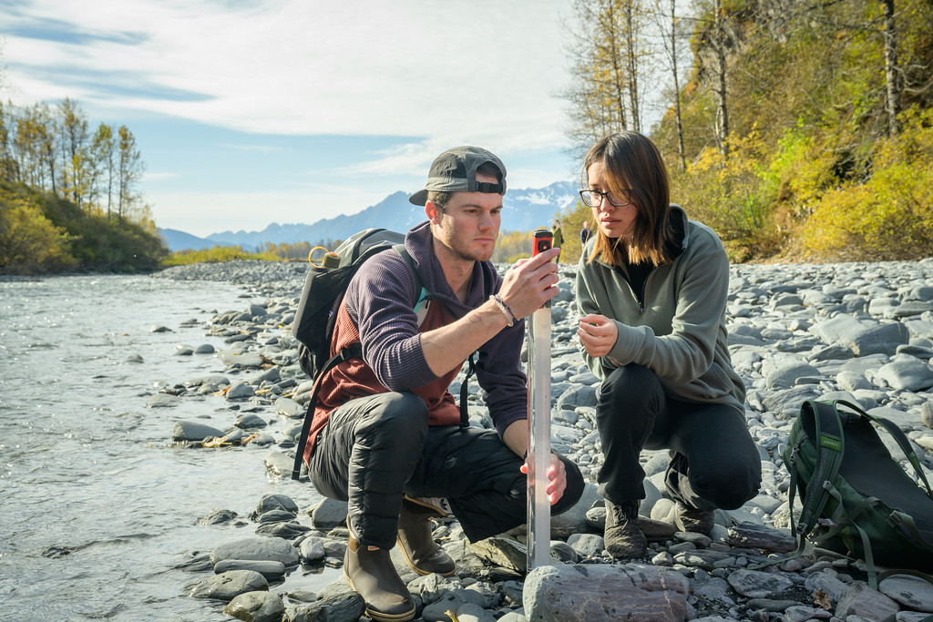 Henry Wessels and Madalyn Yazzie sample water and take measurements along Mineral Creek
