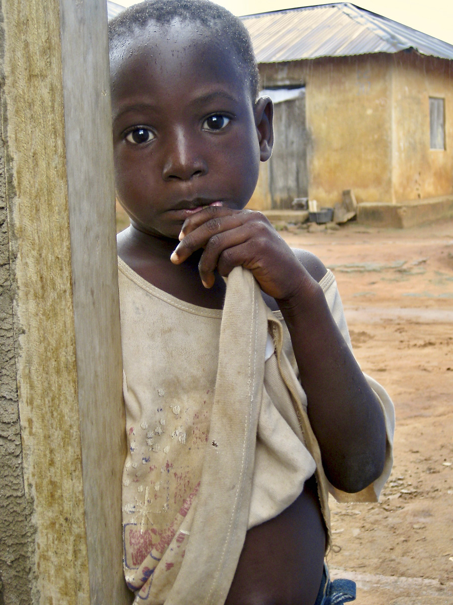 African child peaking around corner