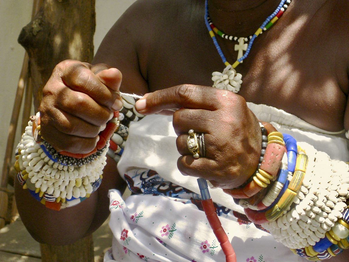 Dashi's hands as they string up beads