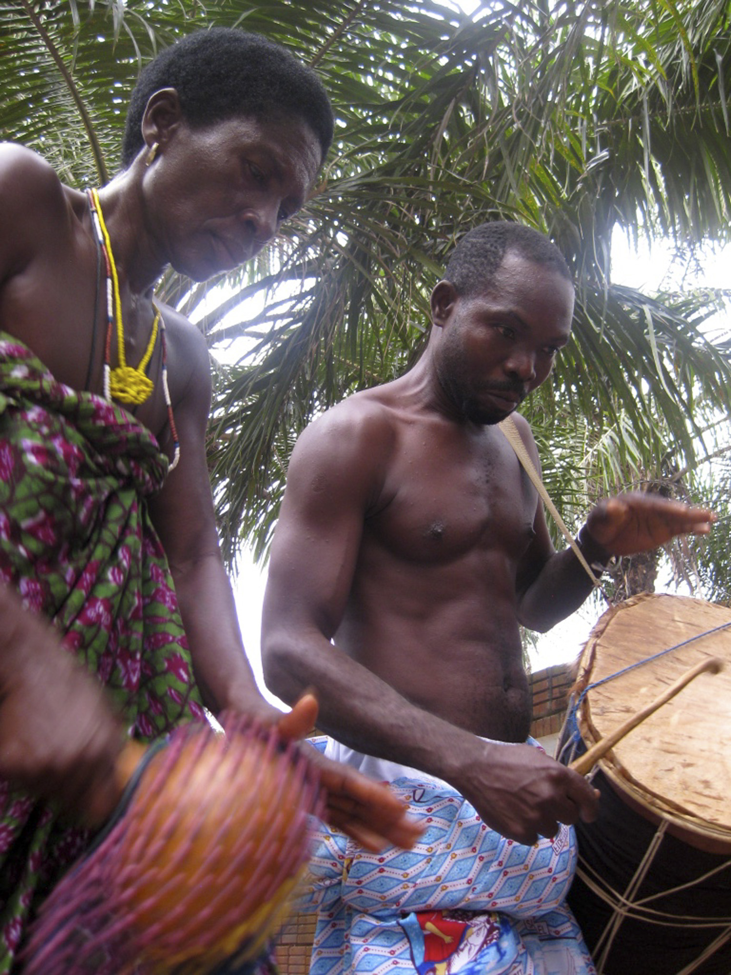 Woman playing the maraca and man playing drum