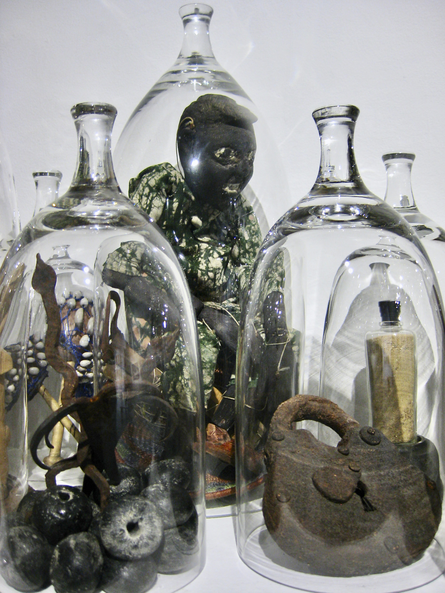 lock and beads under glass cloche