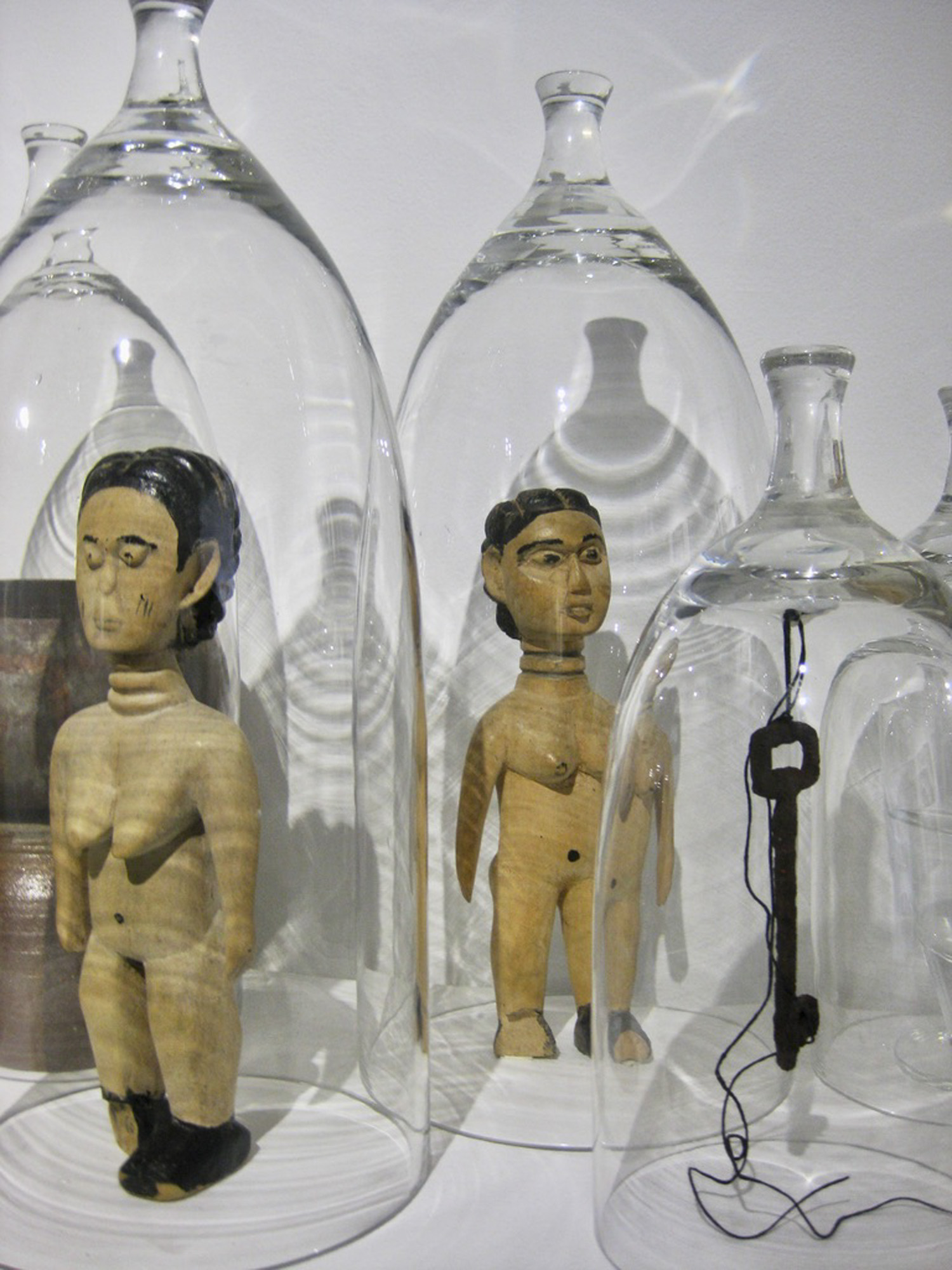 Wooden figures under glass