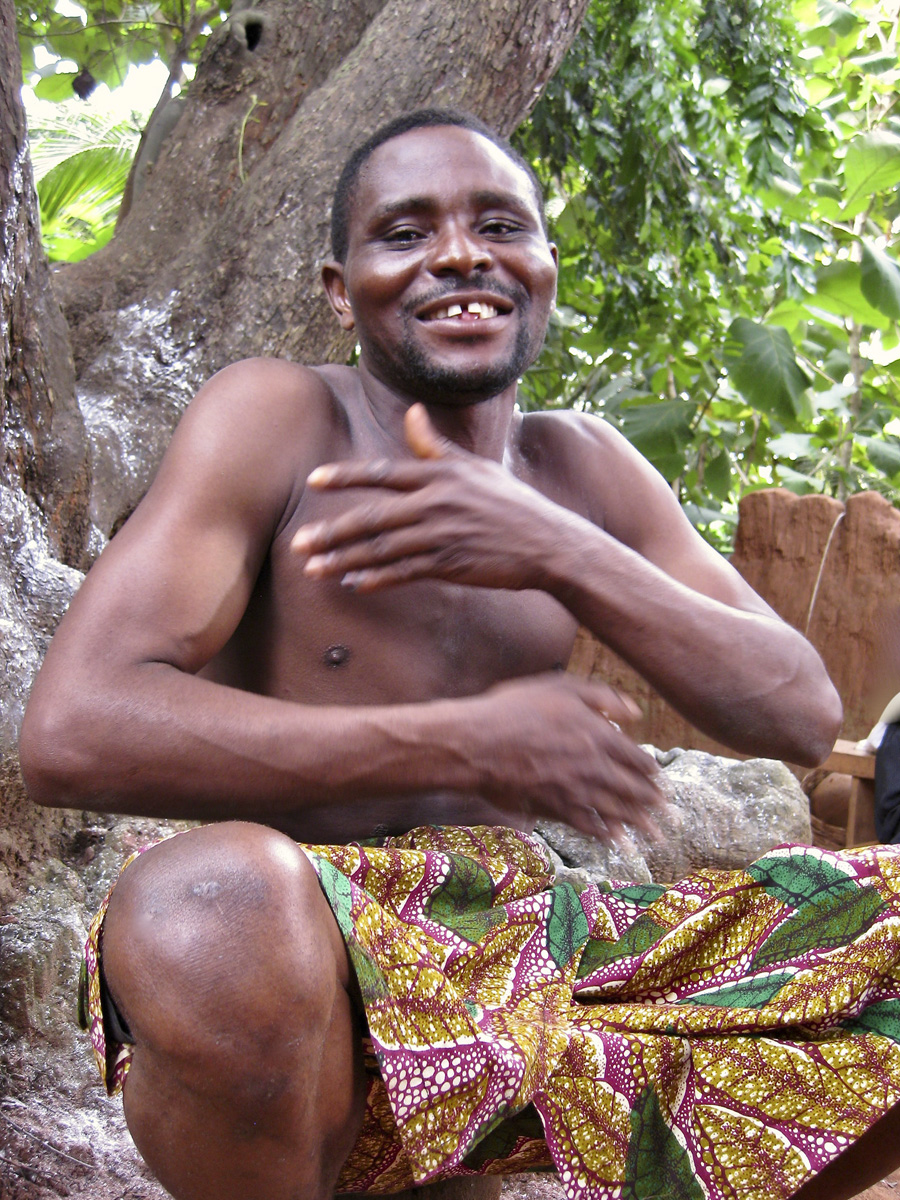 African man drumming against his chest