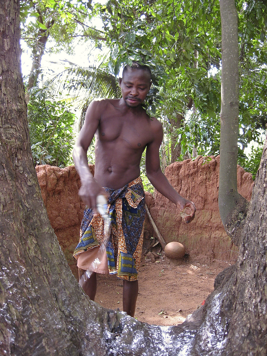 Man standing over shrine