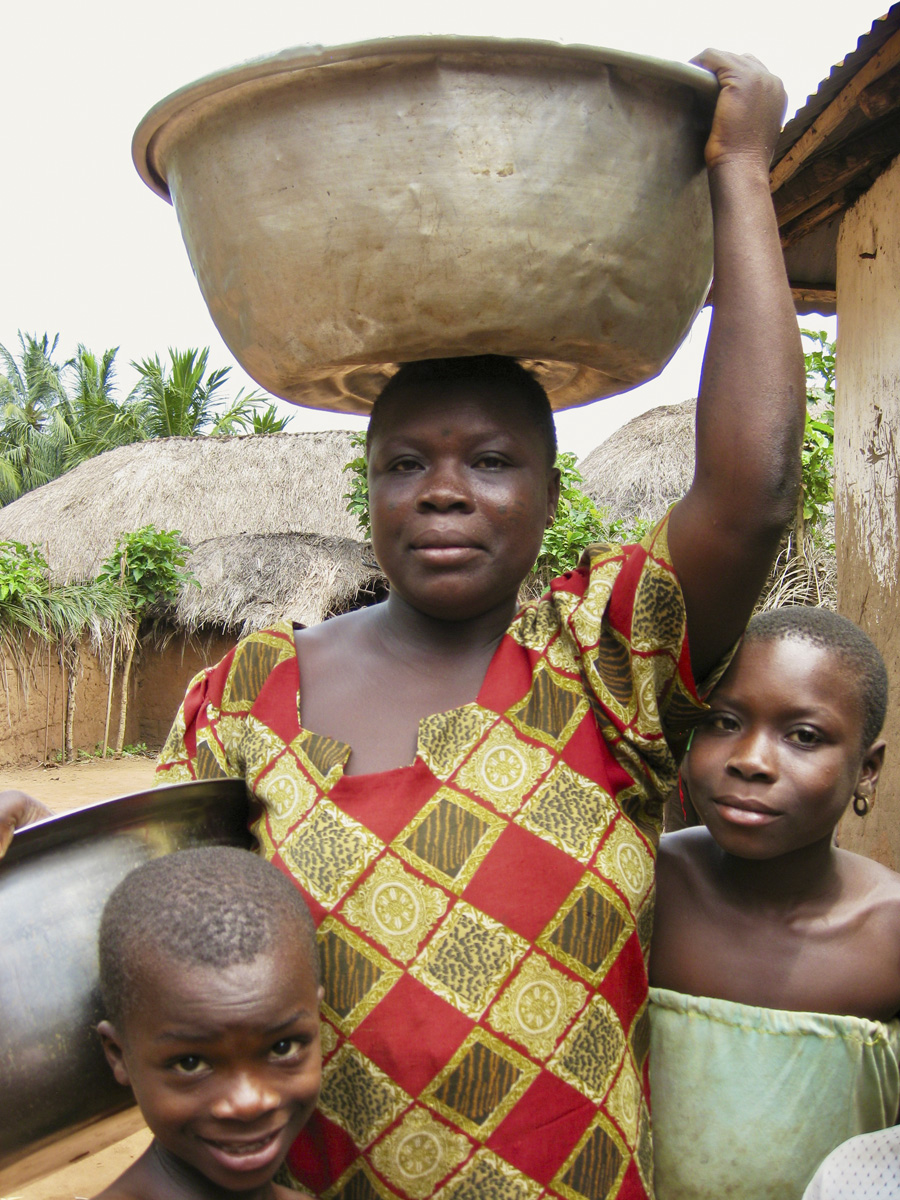 Woman with pot on head and two children