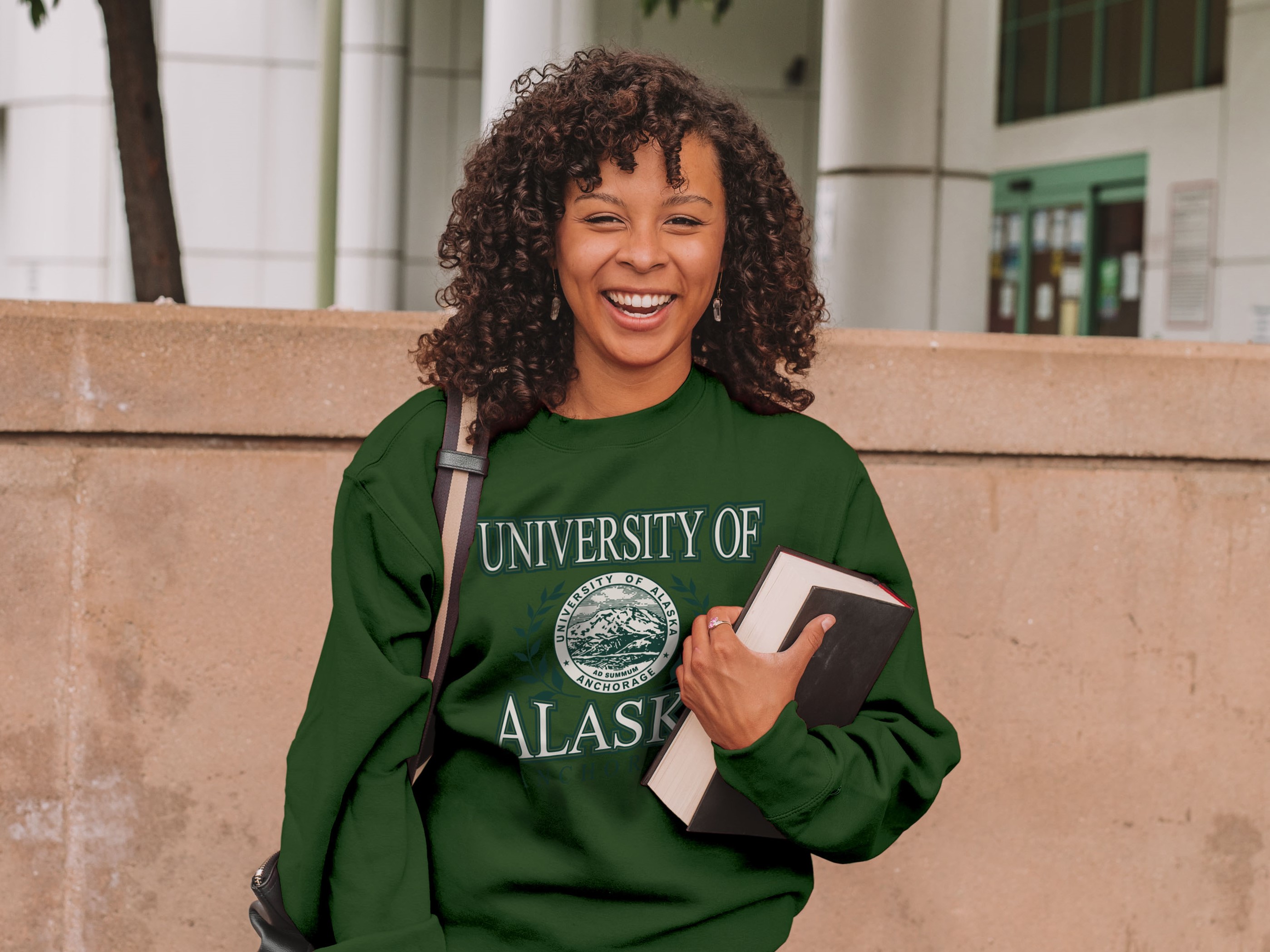 Student wearing green UAA sweatshirt