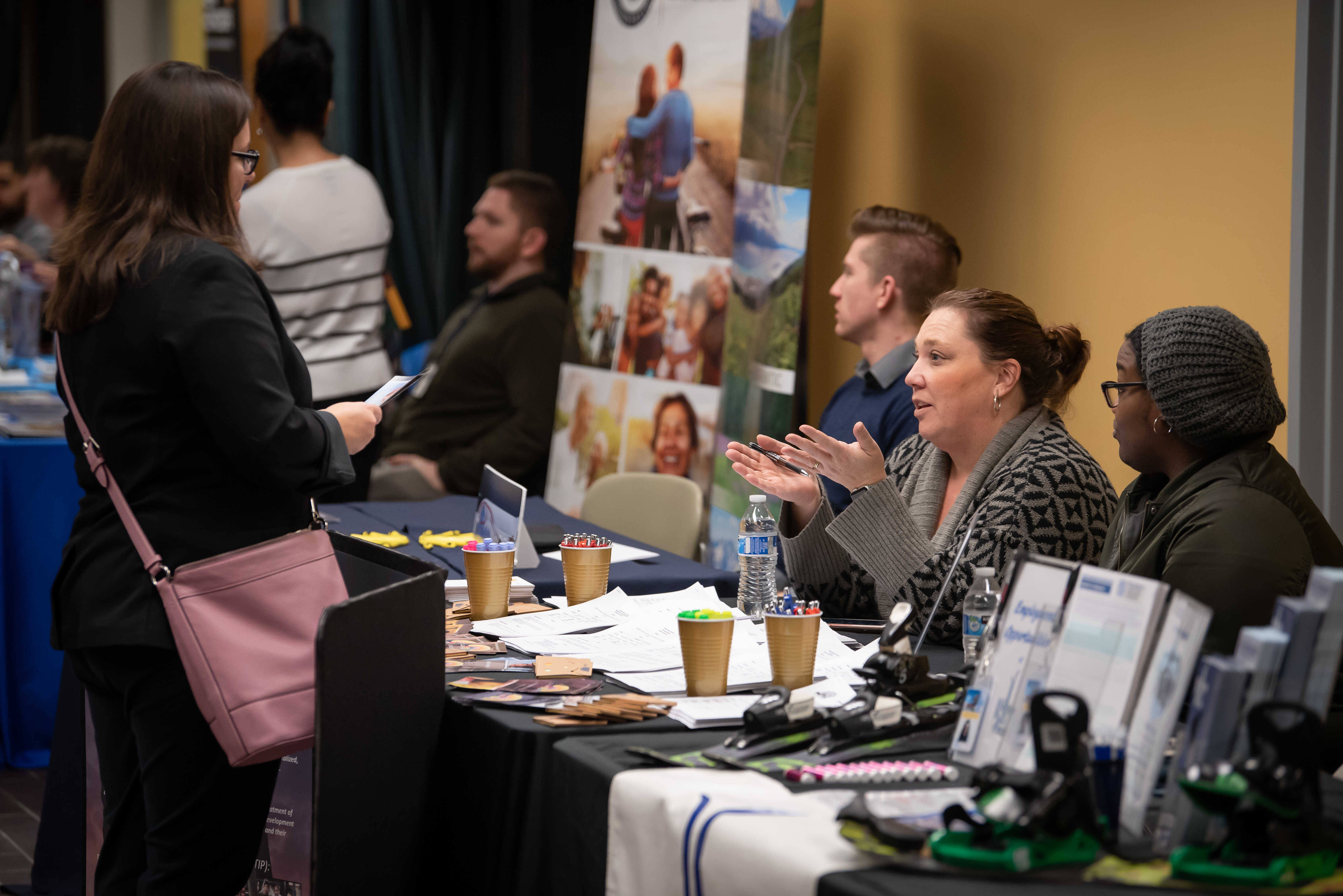 student talking with employers at a recruiting event